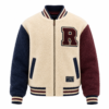 Cream sherpa varsity jacket with navy and maroon sleeves and letter patch