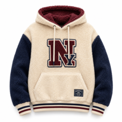 Cream sherpa varsity hoodie with navy sleeves and chenille letter patch